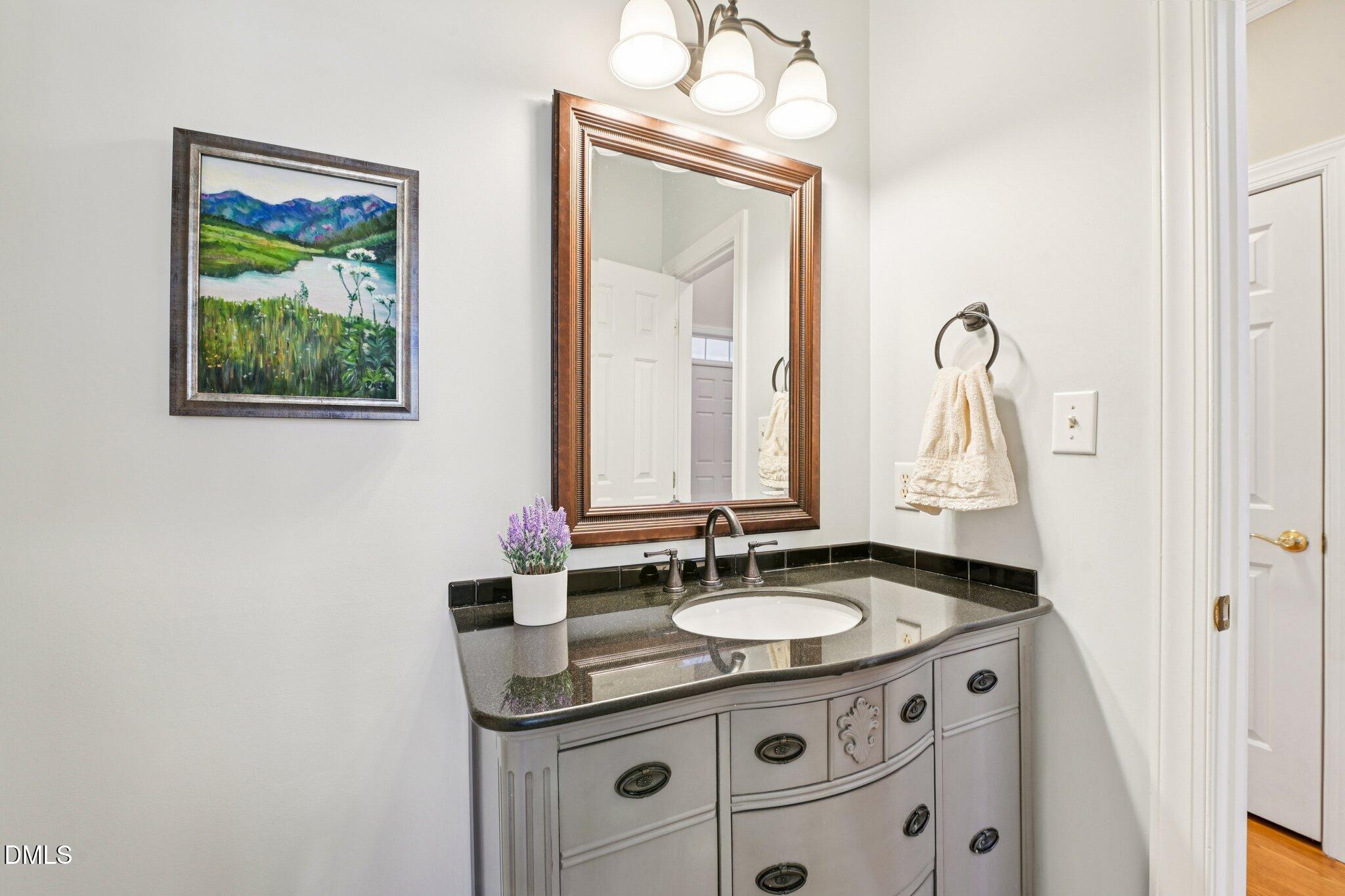 200 Ridge Creek Drive Morrisville, NC 27560 - Photo 20 of 38 a bathroom with a granite countertop sink a mirror and a window