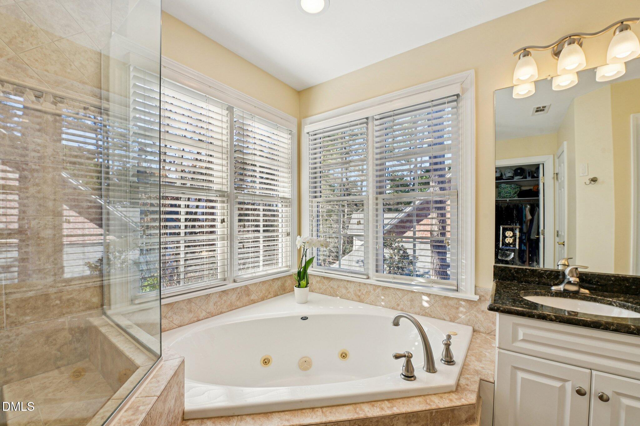 200 Ridge Creek Drive Morrisville, NC 27560 - Photo 24 of 38 a bathroom with a granite countertop tub and a sink
