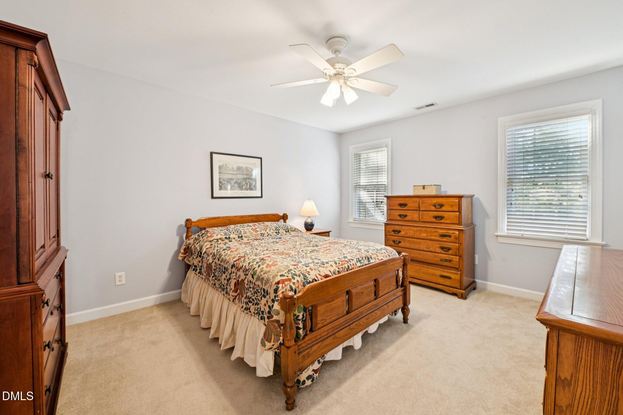 200 Ridge Creek Drive Morrisville, NC 27560 - Photo 26 of 38 a bedroom with a bed and a chandelier