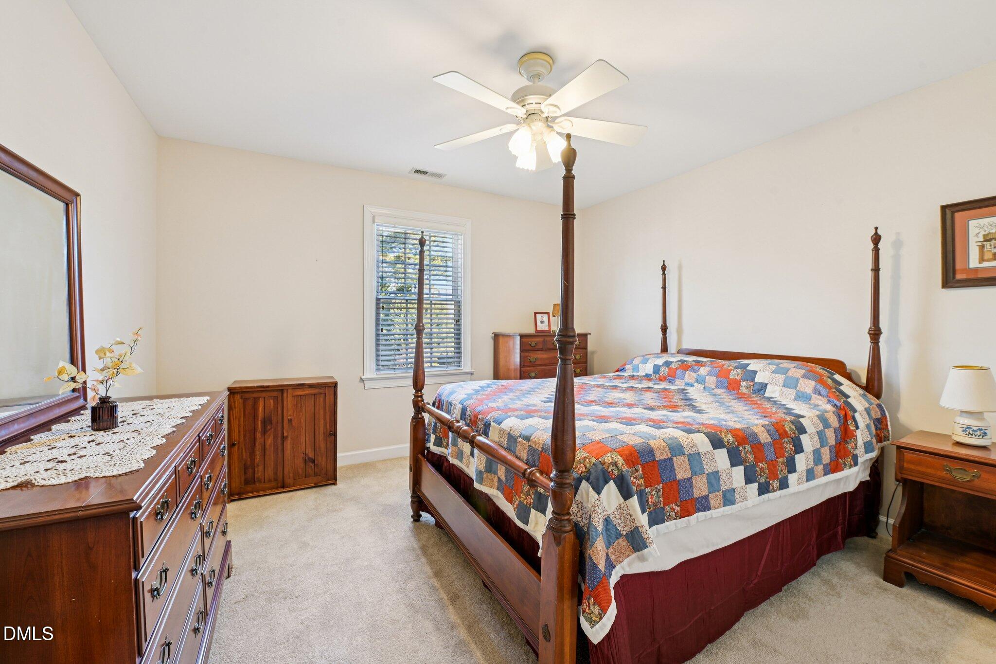 200 Ridge Creek Drive Morrisville, NC 27560 - Photo 27 of 38 a bedroom with a bed and a chandelier