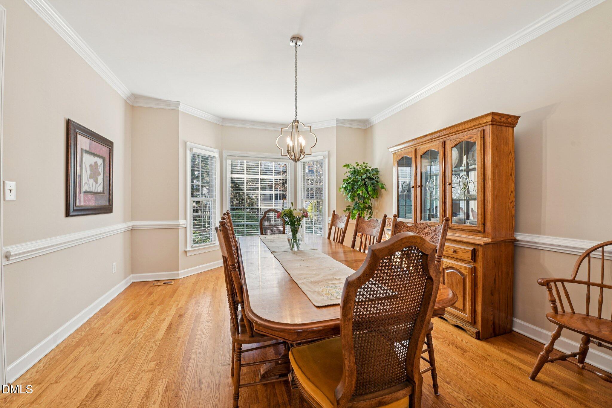 200 Ridge Creek Drive Morrisville, NC 27560 - Photo 8 of 38 a view of a dining room with furniture window and wooden floor