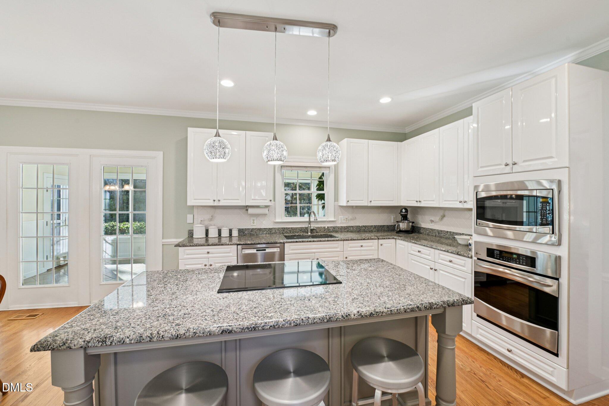 200 Ridge Creek Drive Morrisville, NC 27560 - Photo 9 of 38 a kitchen with granite countertop stainless steel appliances a sink stove and microwave
