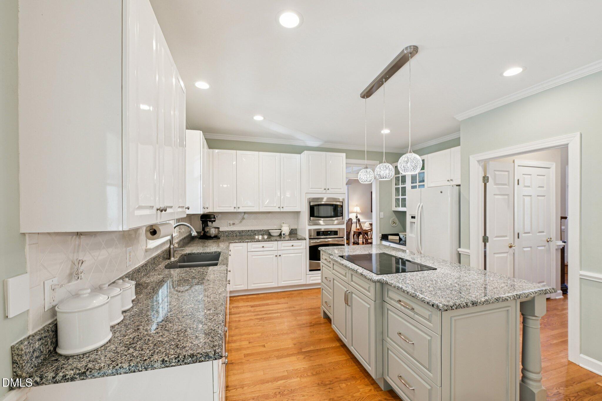 200 Ridge Creek Drive Morrisville, NC 27560 - Photo 10 of 38 a kitchen with stainless steel appliances granite countertop a sink stove and refrigerator