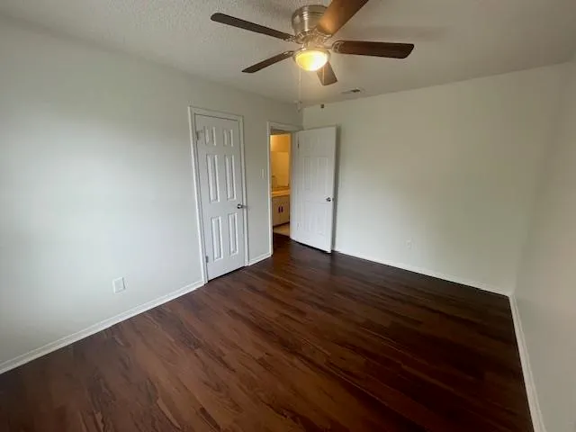 a view of a room with wooden floor and windows