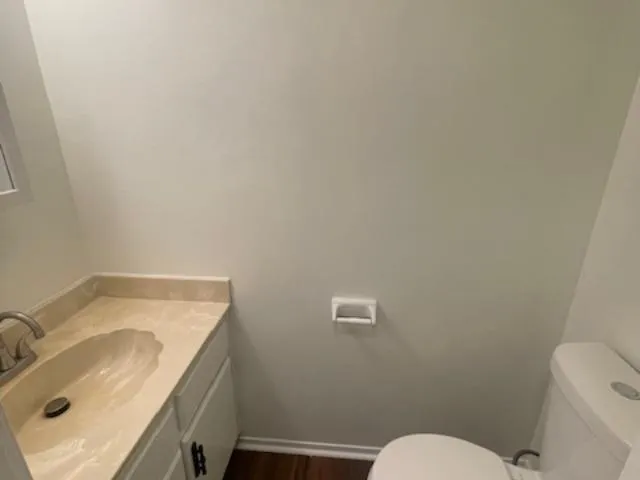 a white toilet sitting next to a bathroom sink