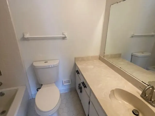 a white bath tub sitting next to a toilet