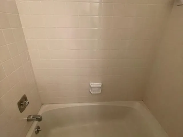 a bathroom with a granite countertop toilet and a sink