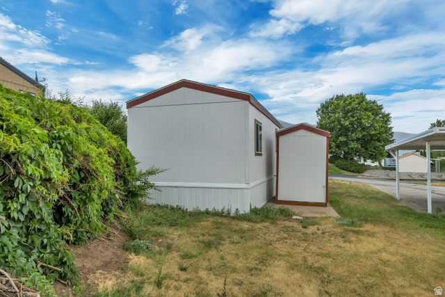 142 Cushing Way Layton, UT 84041 - Photo 12 of 15 White siding exterior with a red trim roofline