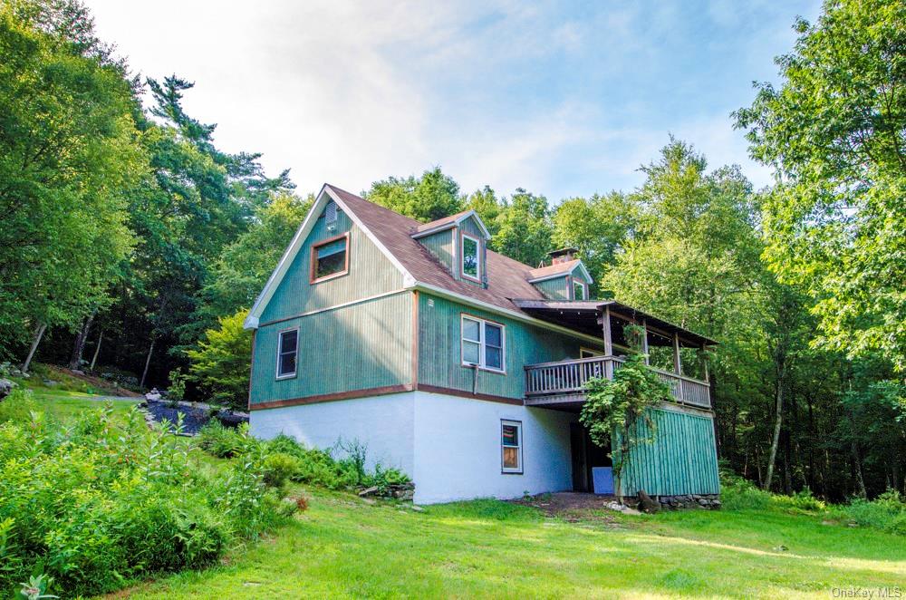 a front view of house with a garden
