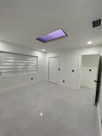 a view of a room with window and a ceiling fan