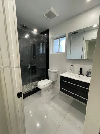 a spacious bedroom with a bed and a lamp