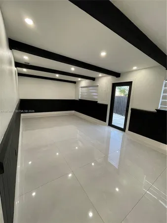 a view of a backyard with wooden fence