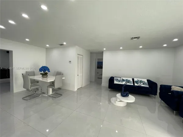 a living room with furniture and a gym equipment