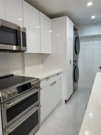 a kitchen with stainless steel appliances a stove a microwave and cabinets