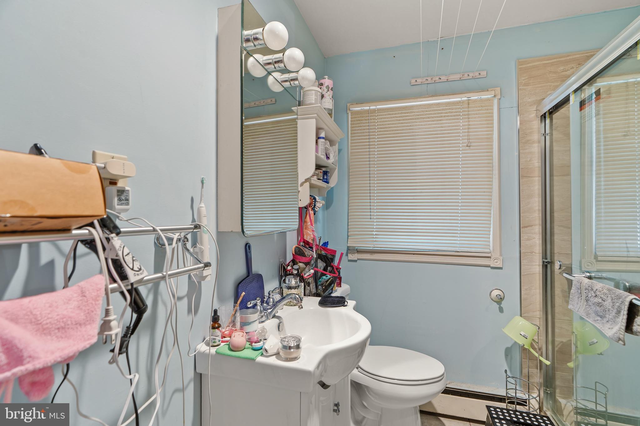 1205 Nottingham Road Newark, DE 19711 - Photo 28 of 47 a bathroom with a toilet sink and mirror