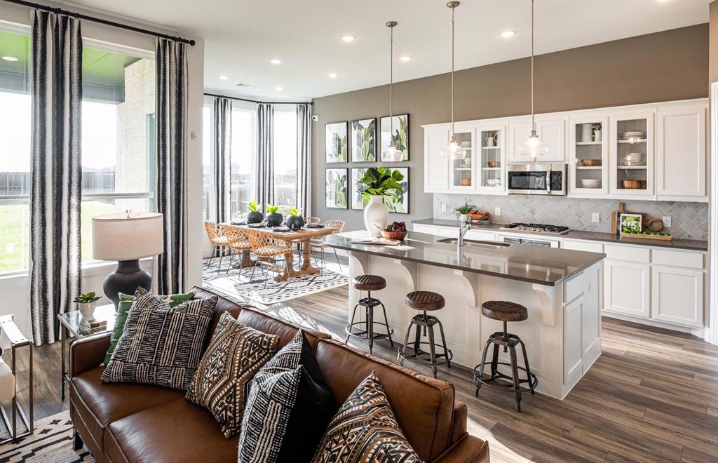 1222 Abbeygreen Road Forney, TX 75126 - Photo 12 of 29 a dining table with stainless steel appliances granite countertop a couch a dining table and chairs