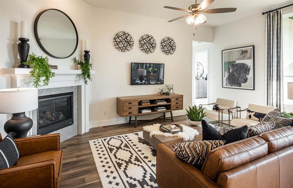 1222 Abbeygreen Road Forney, TX 75126 - Photo 14 of 29 a living room with furniture a mirror and a fireplace