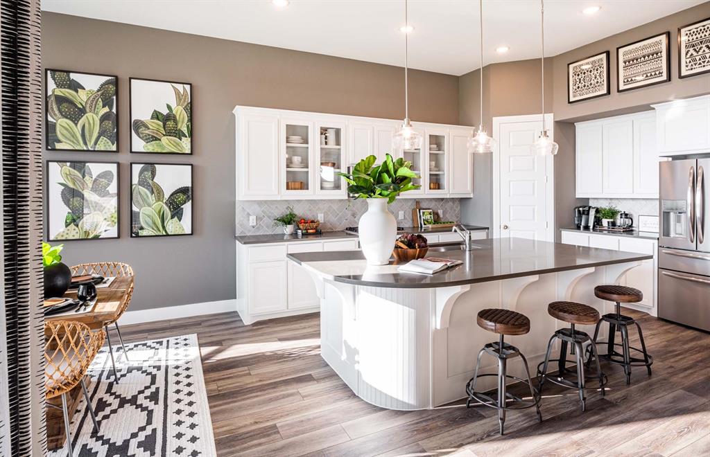 1222 Abbeygreen Road Forney, TX 75126 - Photo 9 of 29 a kitchen with a table chairs stove and cabinets