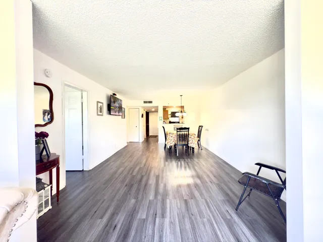a dining room with furniture and wooden floor