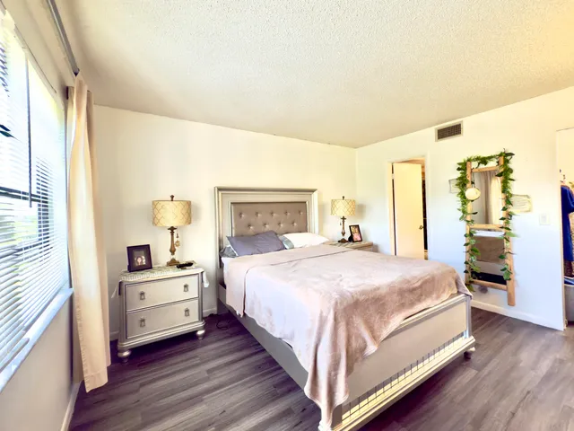 a bedroom with a bed and a large window