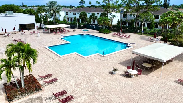 a view of a backyard with swimming pool