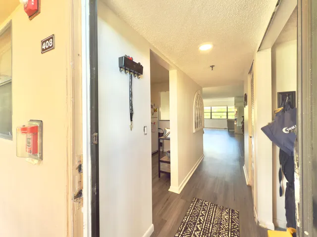 a view of hallway with wooden floor