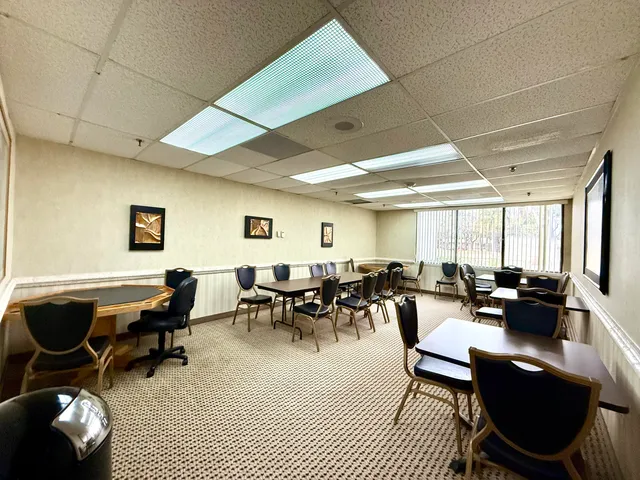a living room with lots of furniture and a large window