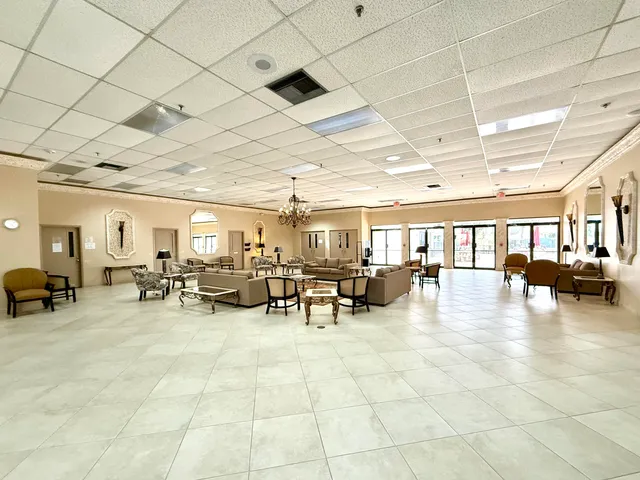 a living room with furniture a rug and a book shelf