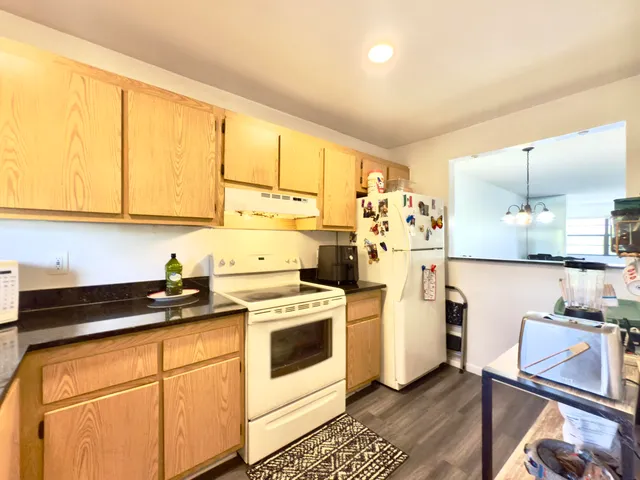 a kitchen with a stove a sink and a refrigerator