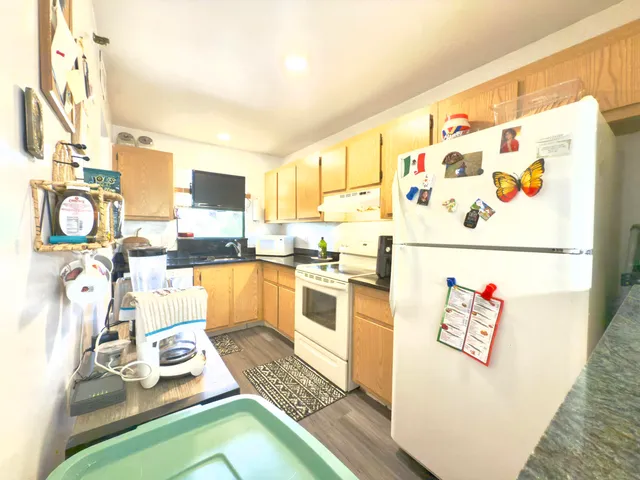 a kitchen with a refrigerator and a stove top oven