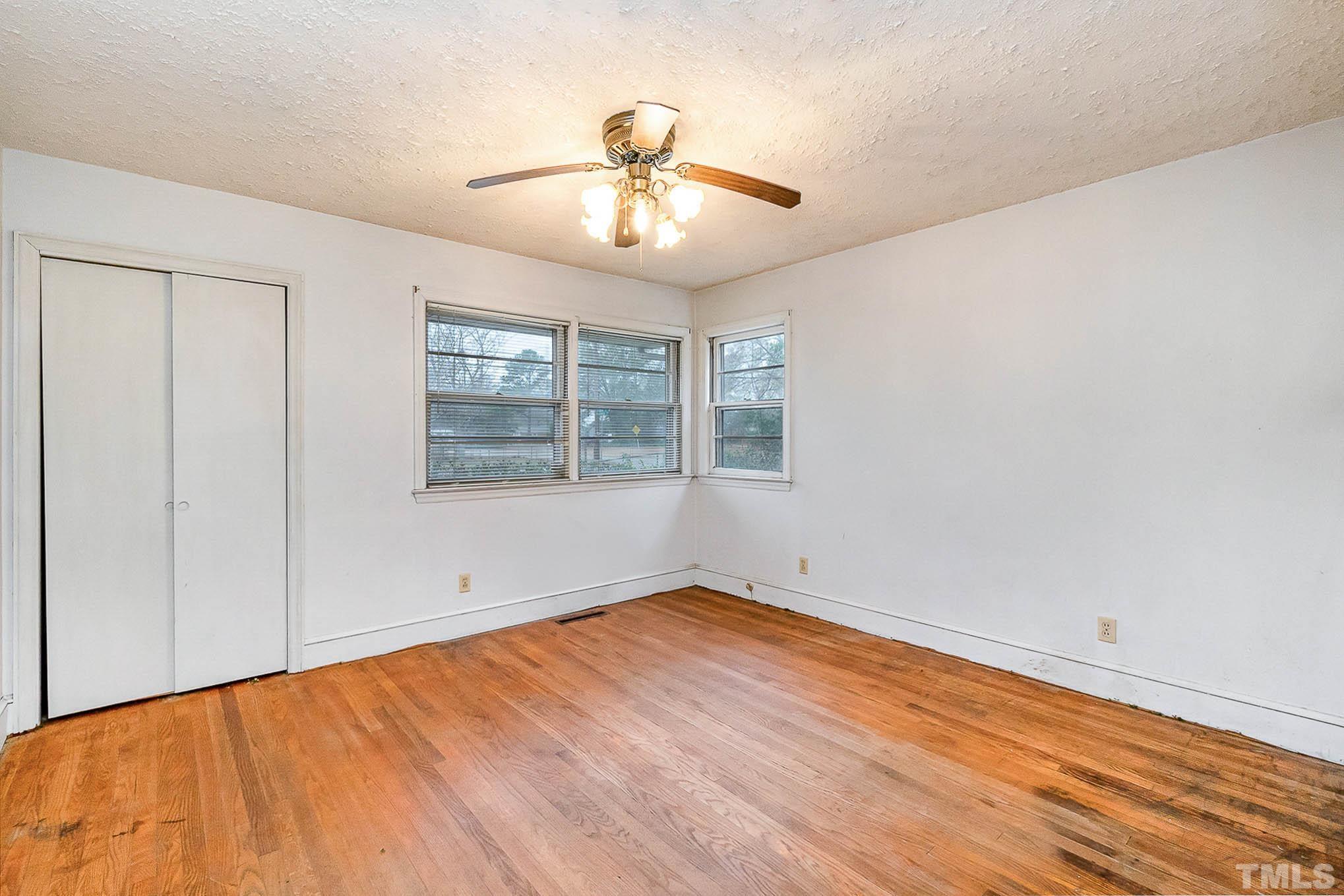 4874 Cameron Road Hope Mills, NC 28348 - Photo 13 of 21 wooden floor in an empty room with a window