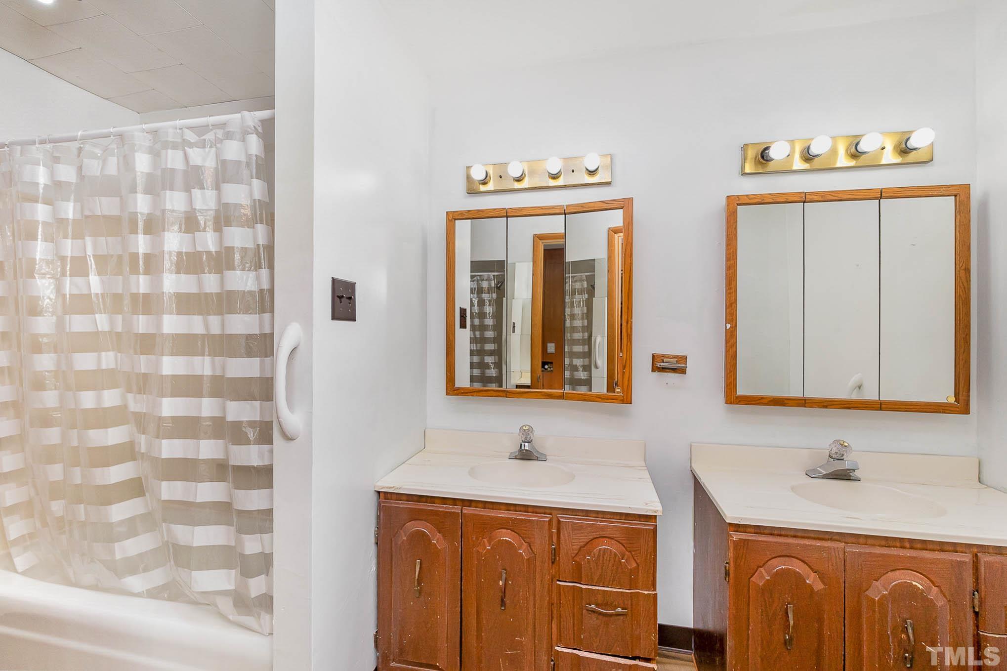 4874 Cameron Road Hope Mills, NC 28348 - Photo 17 of 21 a bathroom with double sink and mirror