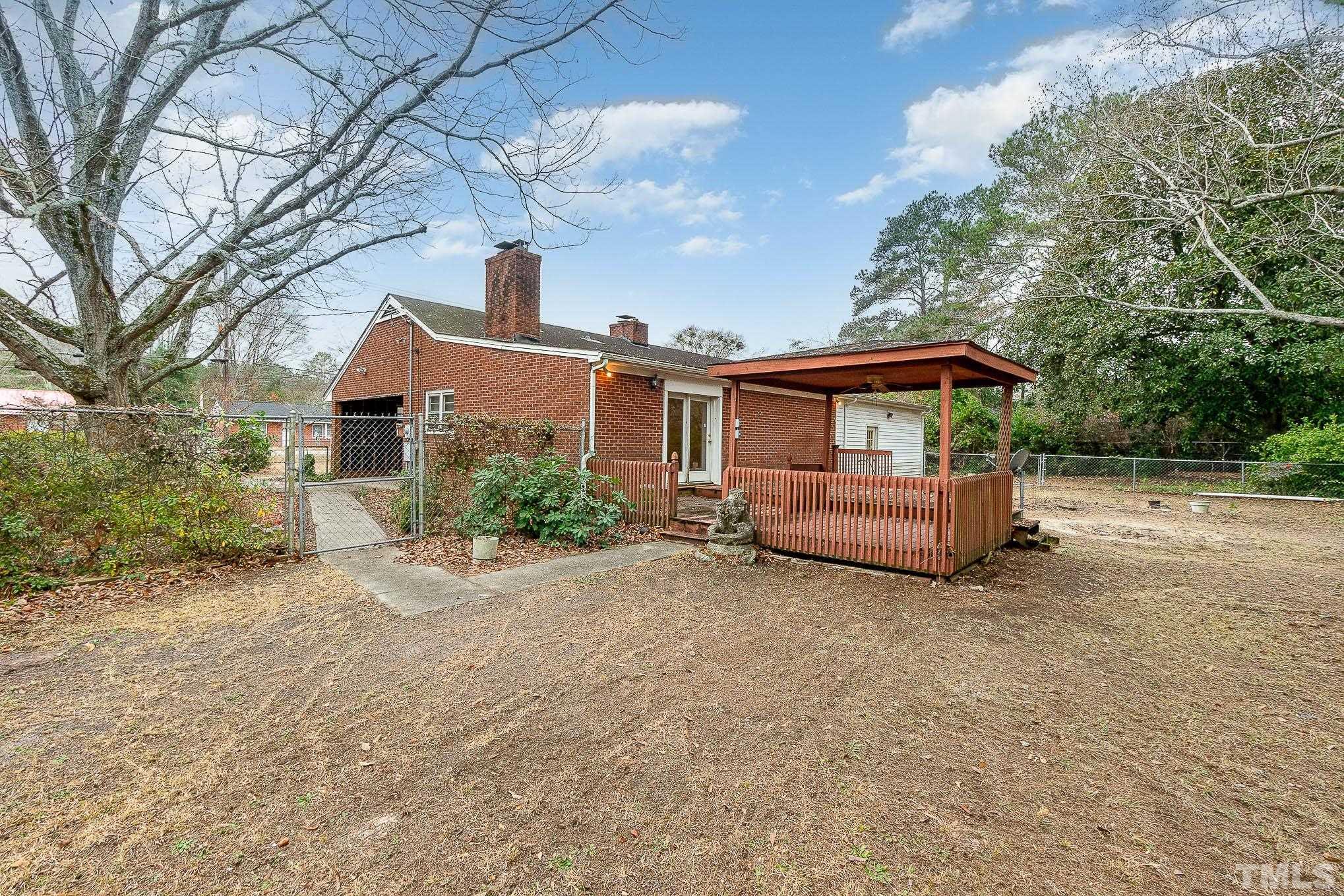 4874 Cameron Road Hope Mills, NC 28348 - Photo 18 of 21 a view of a house with large trees and wooden fence