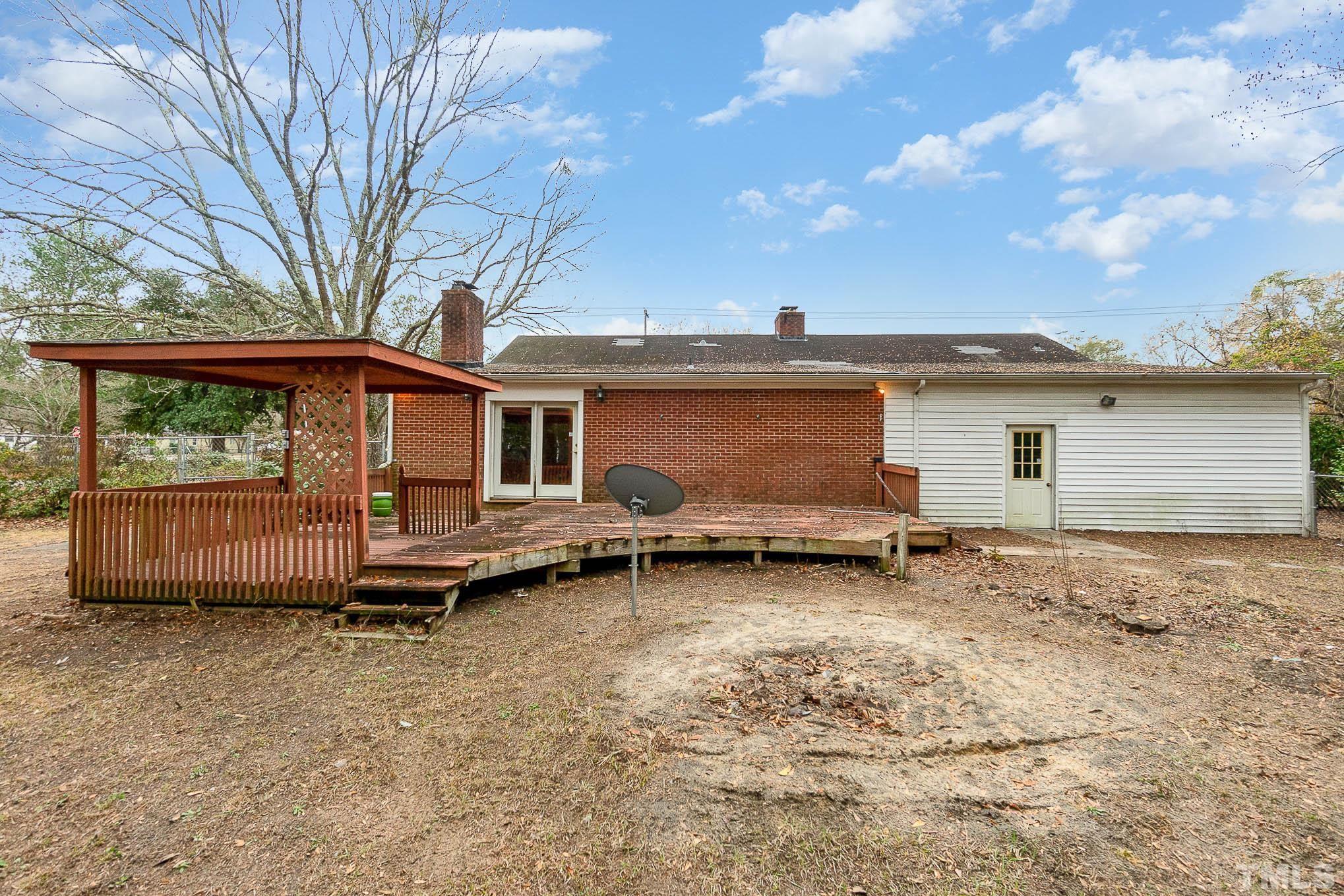 4874 Cameron Road Hope Mills, NC 28348 - Photo 19 of 21 a backyard of a house with barbeque oven table and chairs