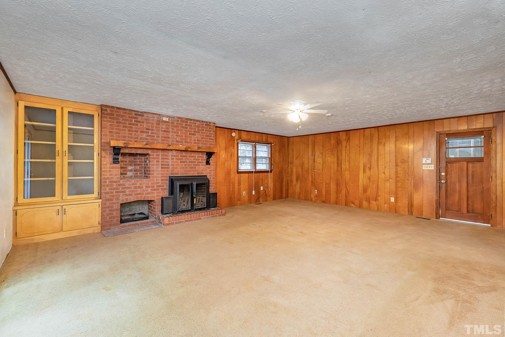 4874 Cameron Road Hope Mills, NC 28348 - Photo 7 of 21 an empty room with furniture and a fireplace