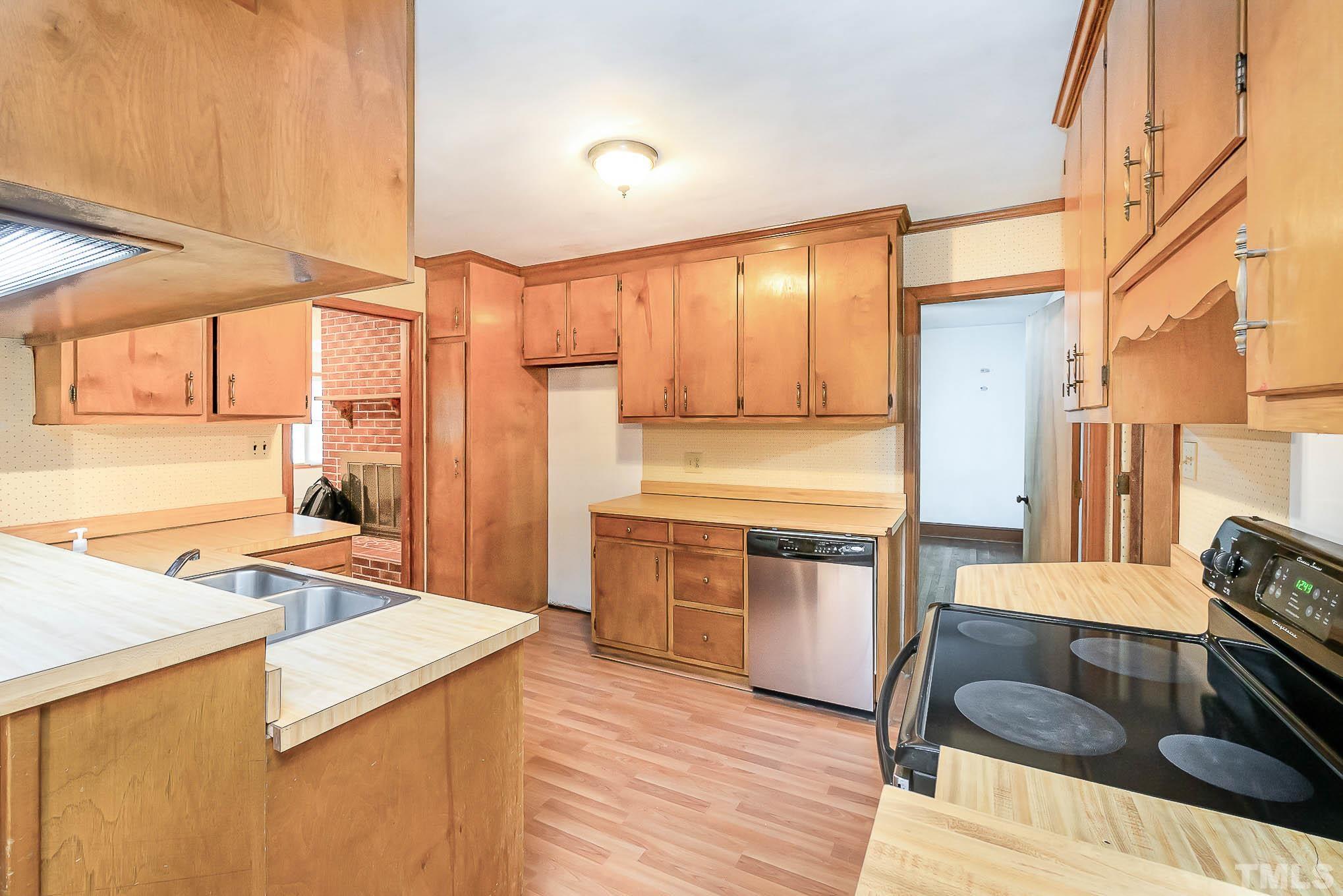 4874 Cameron Road Hope Mills, NC 28348 - Photo 8 of 21 a kitchen with a sink stove and refrigerator
