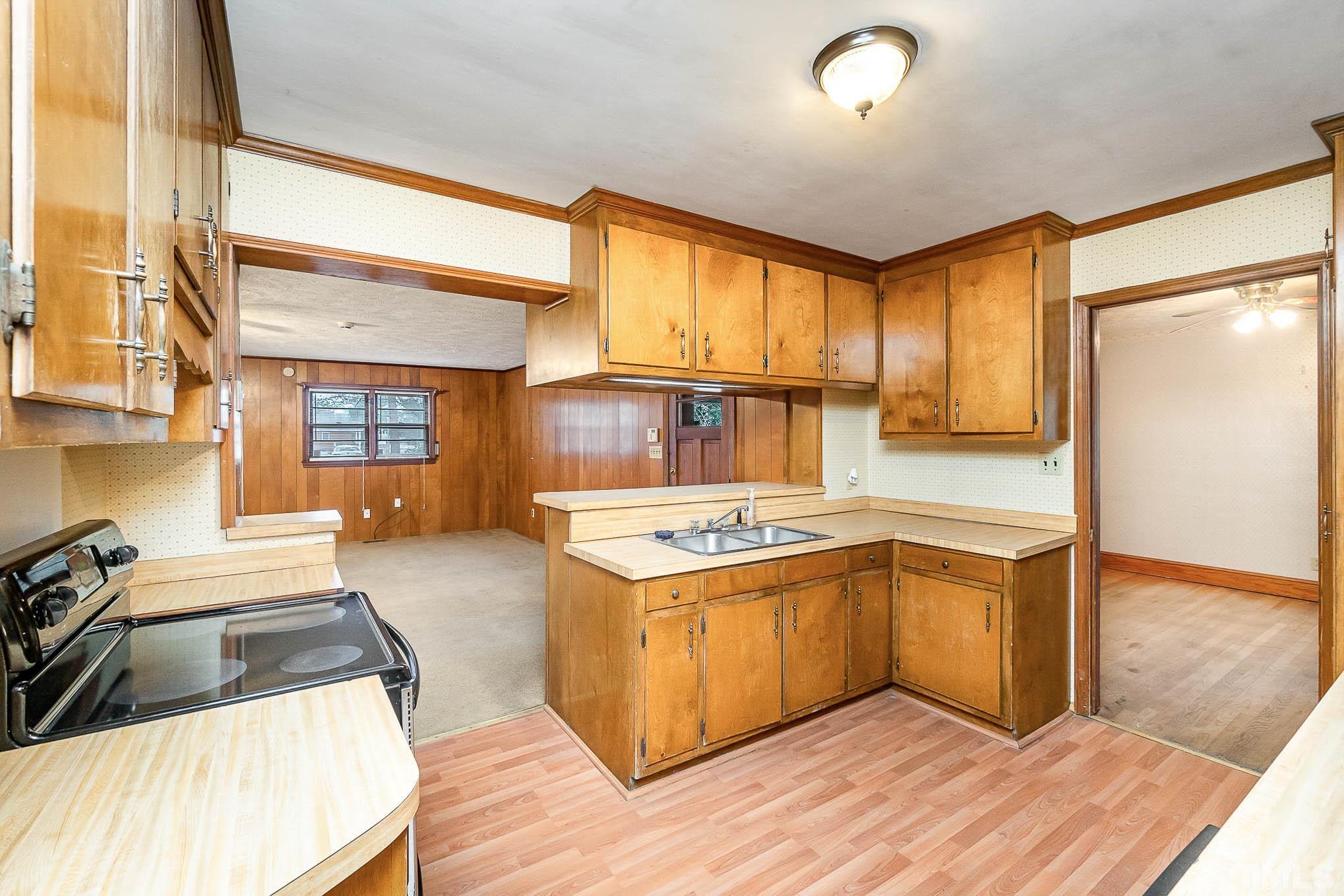 4874 Cameron Road Hope Mills, NC 28348 - Photo 9 of 21 a kitchen with wooden cabinets and a sink