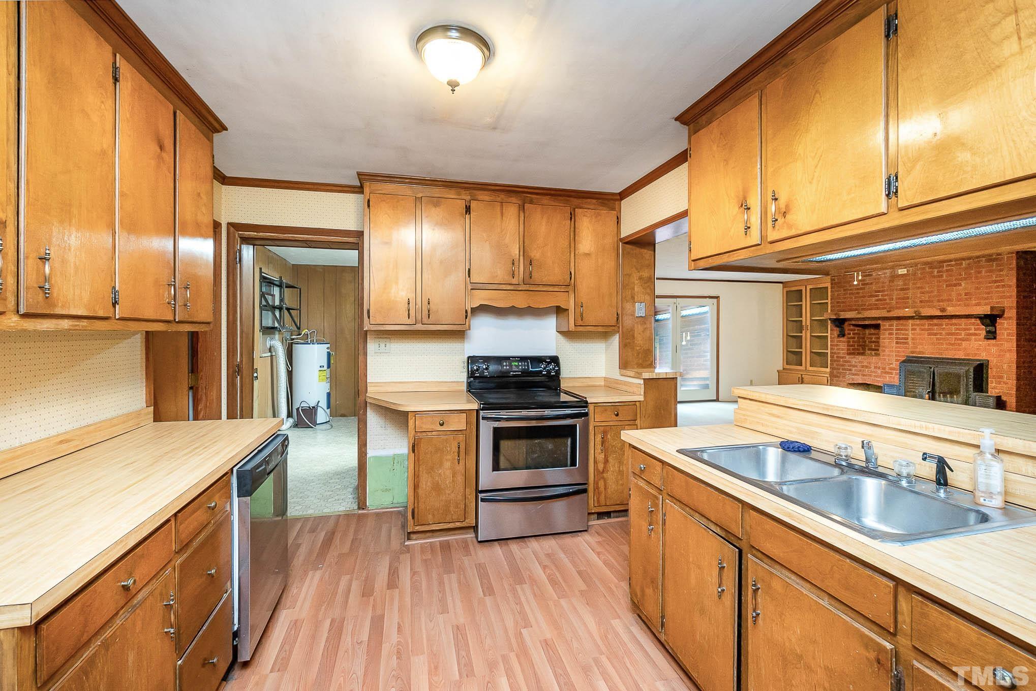 4874 Cameron Road Hope Mills, NC 28348 - Photo 10 of 21 a kitchen with stainless steel appliances granite countertop a stove and a sink
