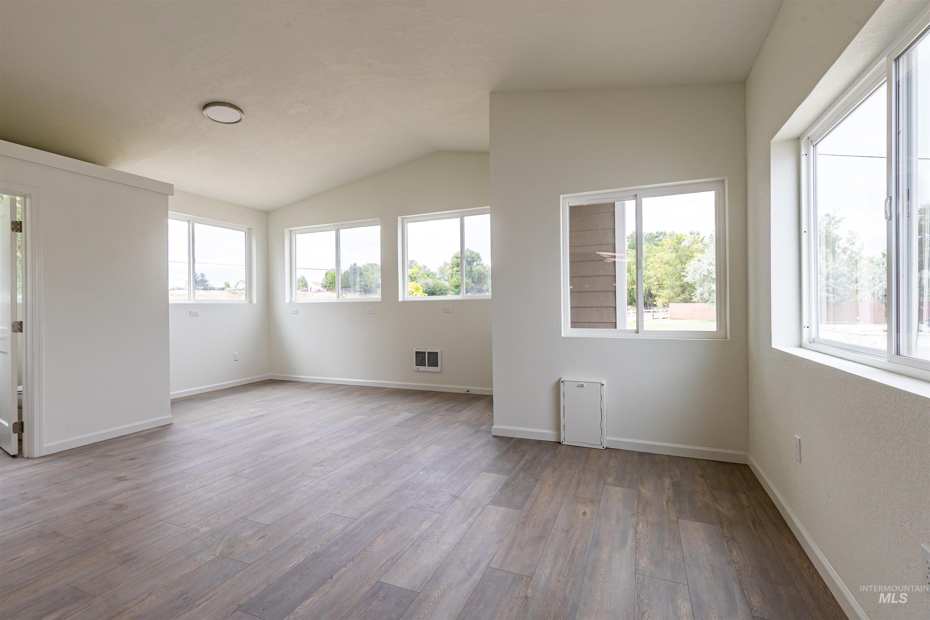 17028 Lower Pleasant Ridge Road Caldwell, ID 83607 - Photo 17 of 21 Spacious room featuring wood-finish flooring and multiple windows