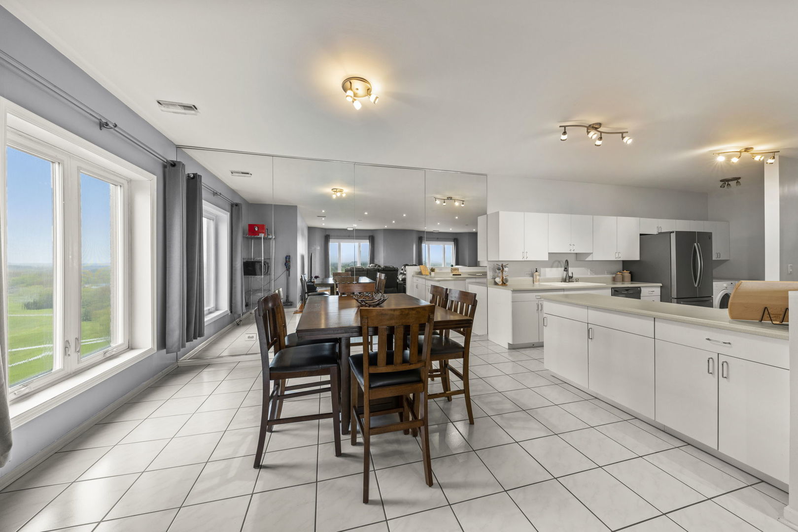 1 Renaissance Place, Unit PH2 Palatine, IL 60067 - Photo 8 of 23 a kitchen with a dining table chairs and white appliances