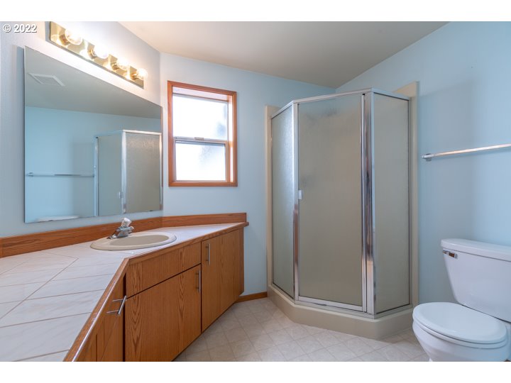 15917 Northeast Union Road, Unit 29 Ridgefield, WA 98642 - Photo 17 of 31 a bathroom with a granite countertop sink toilet and shower