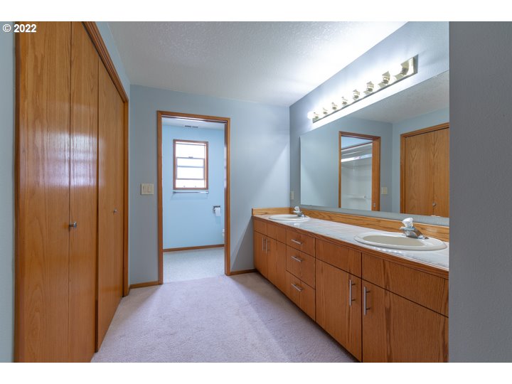 15917 Northeast Union Road, Unit 29 Ridgefield, WA 98642 - Photo 25 of 31 a bathroom with a double vanity sink and a mirror