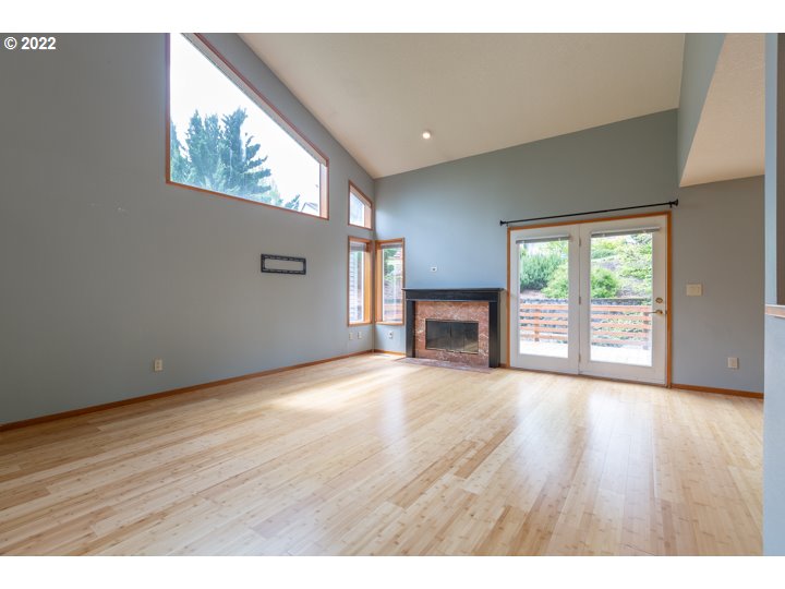 15917 Northeast Union Road, Unit 29 Ridgefield, WA 98642 - Photo 5 of 31 an empty room with wooden floor and fireplace