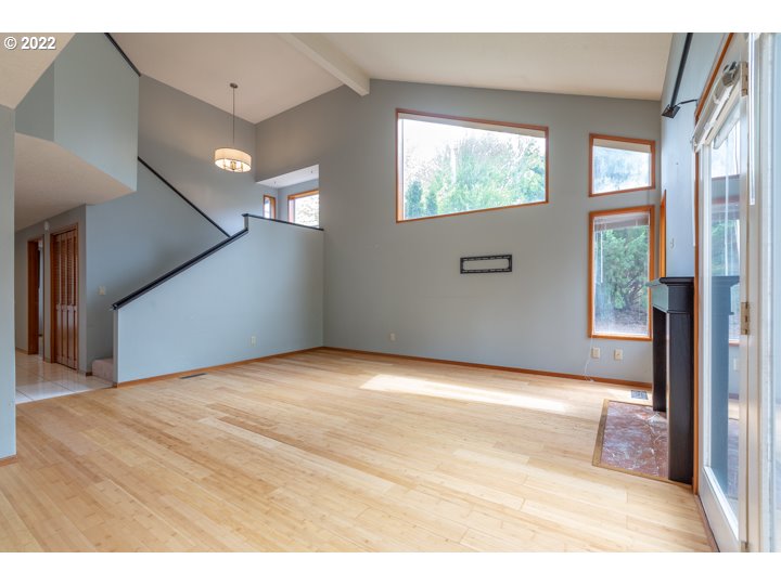 15917 Northeast Union Road, Unit 29 Ridgefield, WA 98642 - Photo 7 of 31 a view of an empty room with wooden floor and a window