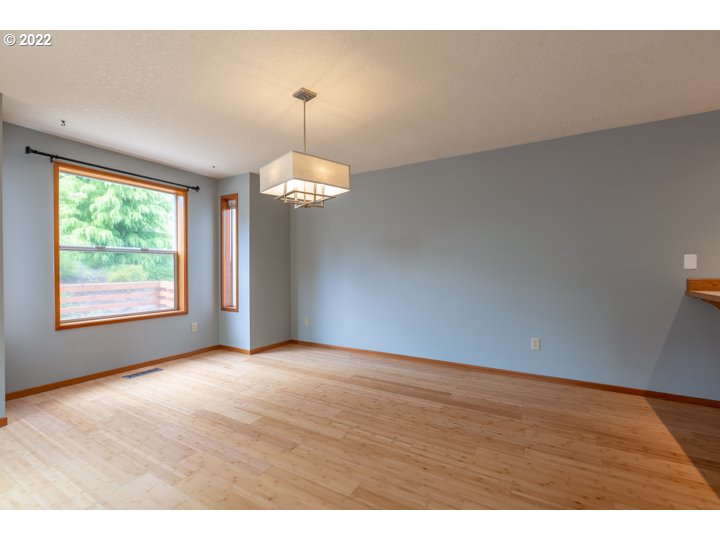 15917 Northeast Union Road, Unit 29 Ridgefield, WA 98642 - Photo 8 of 31 a view of an empty room with wooden floor and a window