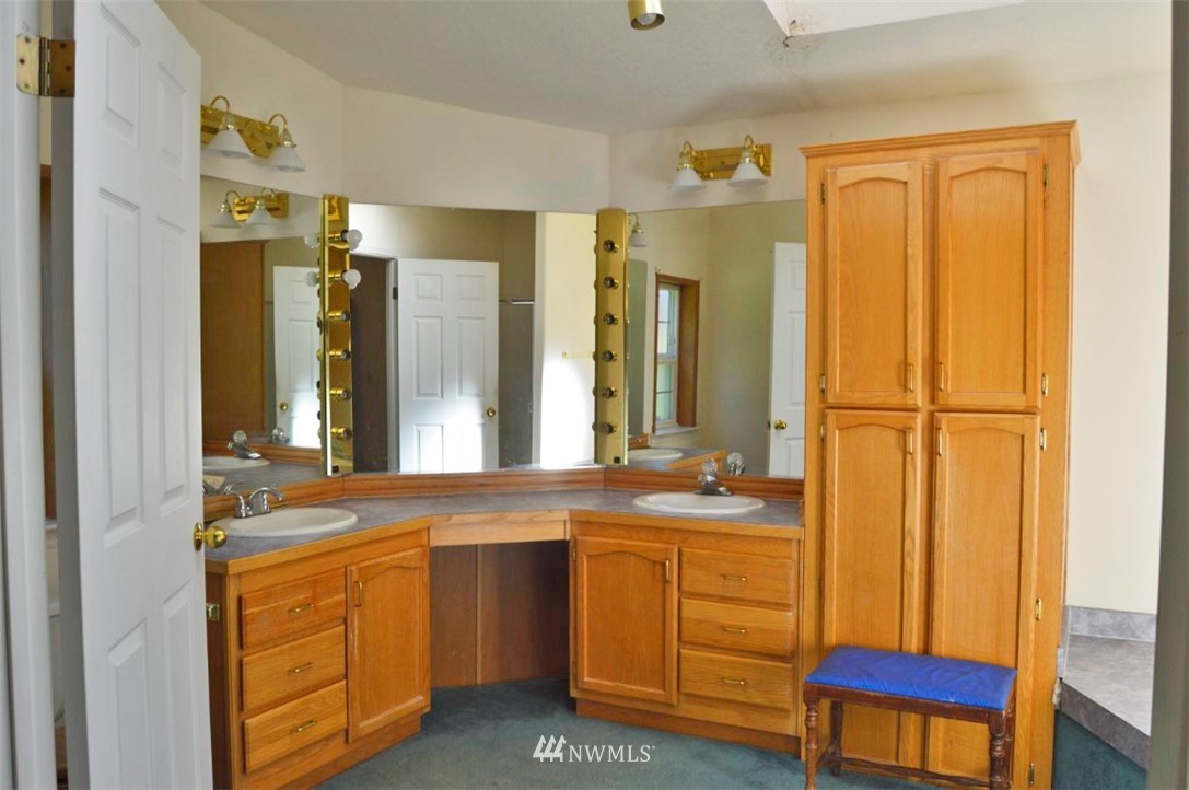 120 Bowers Road Chehalis, WA 98532 - Photo 19 of 31 a bathroom with a double vanity sink a mirror and a bathtub