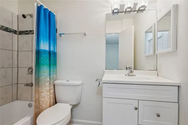a bathroom with a toilet sink and shower