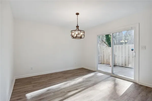 a view of a room with window wooden floor