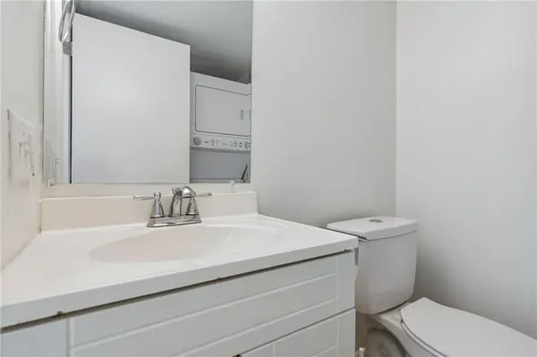a bathroom with a sink toilet and mirror