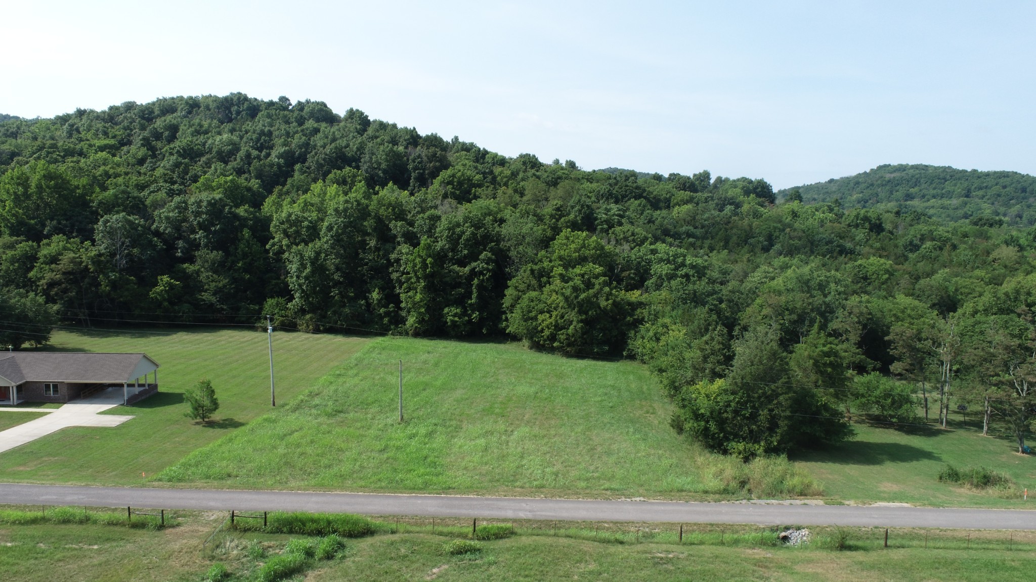0 McClanahan Road Hartsville, TN 37074 - Photo 8 of 11 a view of a grassy area with an trees